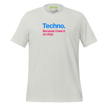 A silver  unisex t-shirt featuring minimalist typography on the chest. The text reads "Techno." in bold blue letters, followed by the subtext "Because i have it on vinyl." in pink. Designed for electronic music fans and vinyl collectors.